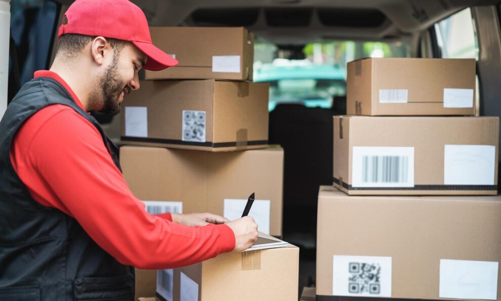 Delivery driver and van full of parcels for delivery